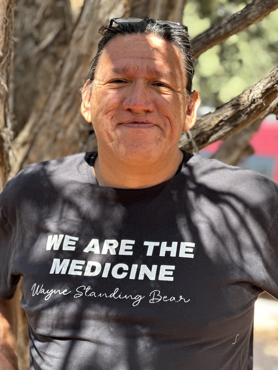 Standing Bears wearing a We Are the Medicine shirt signed Wayne Standing Bear